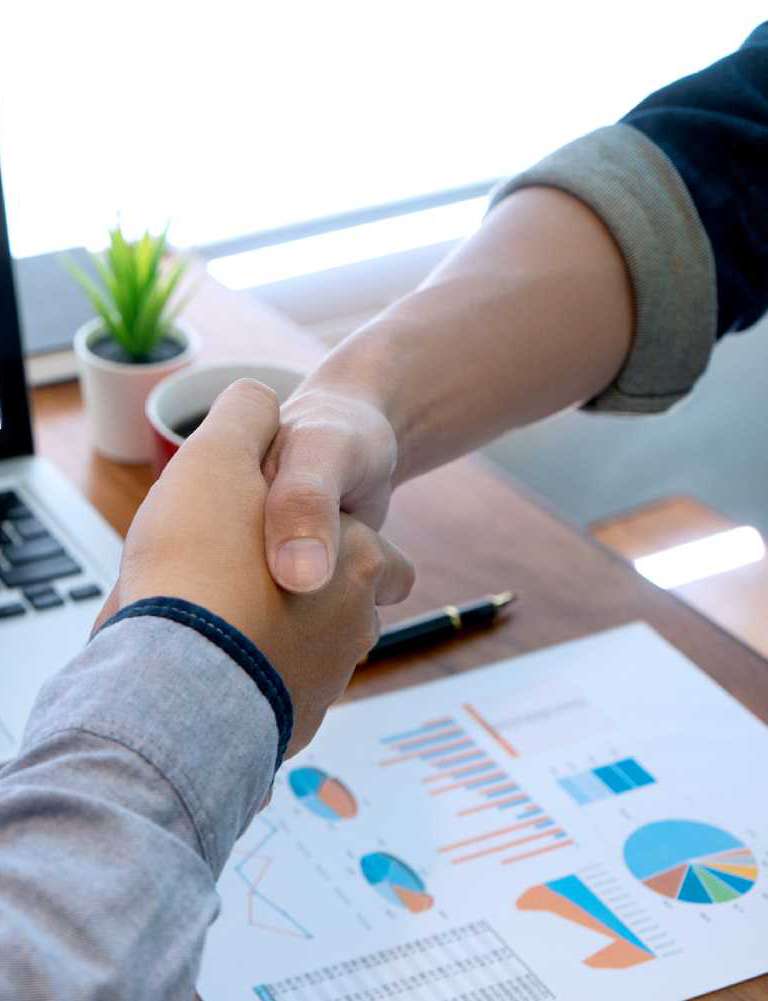 Federal contracting specialists shaking hands with U.S. government contractor/small business owner.